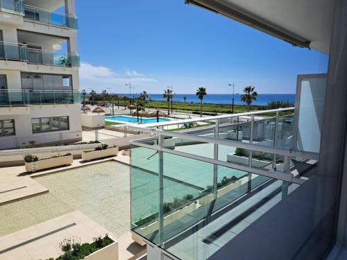 a view of the pool from the balcony of a building at Paraiso Duna 2 Beach Views in Morche
