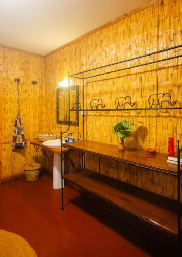 a bathroom with a sink and a mirror and a counter at Octagon Lodge in Karatu
