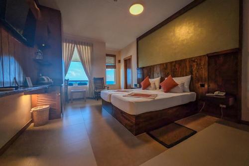 a bedroom with a bed and a desk and a sink at Insight Resort Ahangama in Ahangama