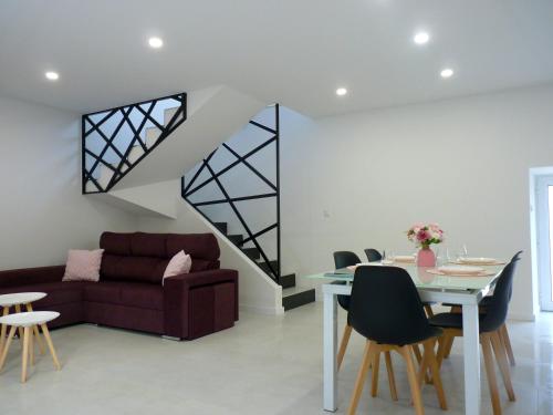 a living room with a couch and a table at Casa das Abelhas in Arcos de Valdevez