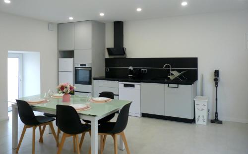 a kitchen with a table and chairs in a room at Casa das Abelhas in Arcos de Valdevez