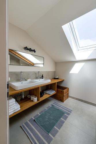 a bathroom with a sink and a skylight at Luxus Villa mit großem Pool Alleinlage Nähe Graz in Erbersdorf