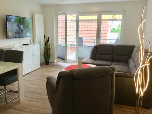 a living room with a couch and a table at Deichnähe B in Norddeich