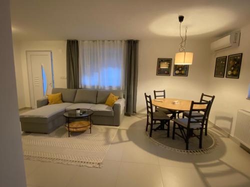 a living room with a couch and a table at Apartman Turić Vinkovci in Vinkovci