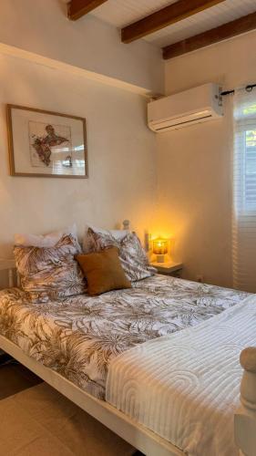 a bedroom with a large bed in a room at Ajoupa Dielcane in Lamentin