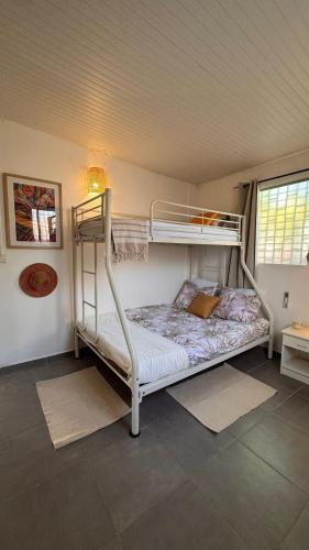 a bedroom with two bunk beds in a room at Ajoupa Dielcane in Lamentin