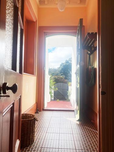 a hallway with an open door to a house at Artists Seaside Sanctuary in St. Leonards