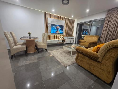 a living room with a couch and chairs and a table at The cozy corner in Hammamet