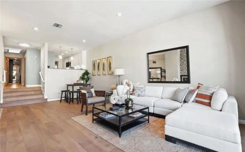 a living room with a white couch and a table at Waterfront Three-Bedroom Condo with Great Views in Naples