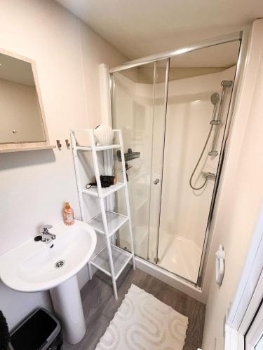 a bathroom with a sink and a shower at Chalet JT08 in Renesse in Renesse