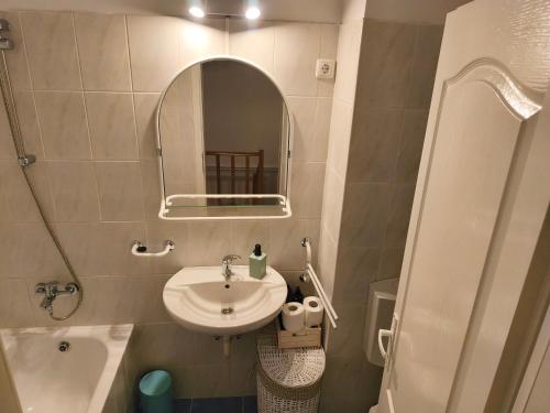 a small bathroom with a sink and a mirror at The Other House in Miercurea-Ciuc