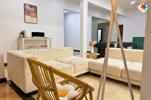 a living room with a couch and a chair at 25P Muji Black & White Kajang Villa with 100" TV in Bandar Baru Bangi