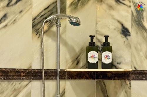 two bottles of wine sitting on a shelf in a shower at 25P Muji Black & White Kajang Villa with 100" TV in Bandar Baru Bangi