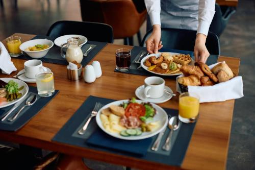 a table with plates of breakfast food on it at Hotel And free shuttle in Istanbul