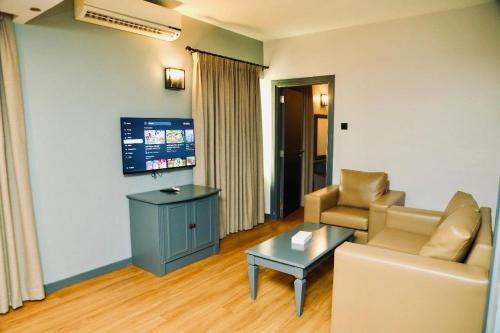 a living room with a couch and a table at Al Sharq Hotel in Sharjah