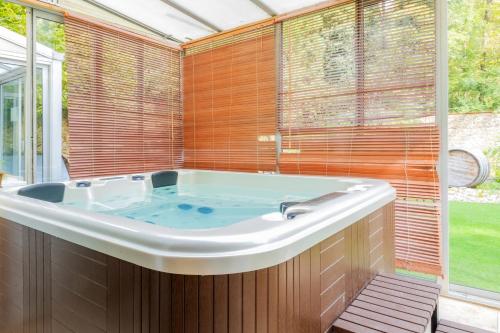 a bath tub in a room with a window at La Maison Mori in Vienne