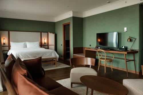 a hotel room with a bed and a television at BODBE Hotel in Sighnaghi