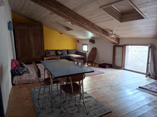 a living room with a table and chairs at Gîte dans La circulade - Le Pouget in Le Pouget
