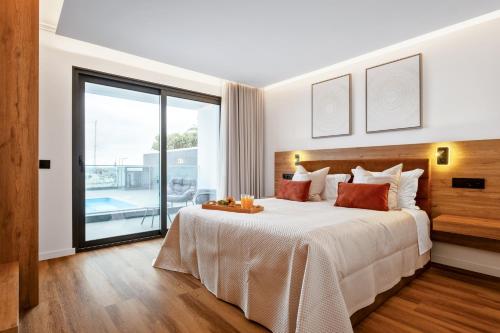 a bedroom with a large bed and a large window at Golden Home V in Caniçal