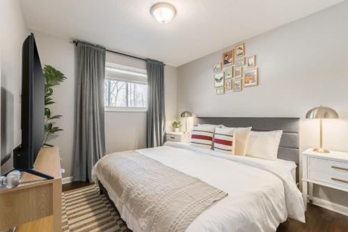a bedroom with a large bed and a television at Apartment Kansas City 15mins to KCI with a KING bed and work desk in Riverside