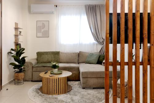 a living room with a couch and a table at The PINE - Stylish city apartment Comfort and Cosiness for 4 in Thessaloniki