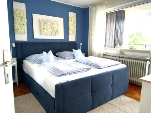 a blue bedroom with a large bed with blue walls at Harz-Fewo-Wolf in Bad Harzburg
