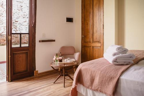 a bedroom with a bed and a table with towels at La Noire Petit hotel in Buenos Aires