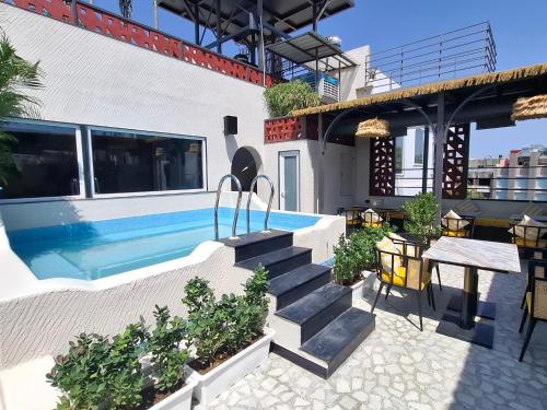 a house with a swimming pool and a statue of a bird at Moustache Jaipur,Hostel & Rooftop Bar in Jaipur