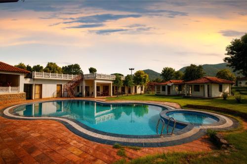 a swimming pool in the yard of a house at Virat Resorts, Sariska Rajasthan in Bairāt