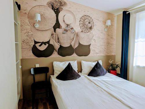 a bedroom with a bed with hats on the wall at Palanga INN in Palanga
