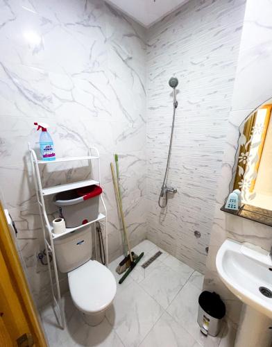 a bathroom with a toilet and a sink at Modern and quiet apartment in Beni Mellal