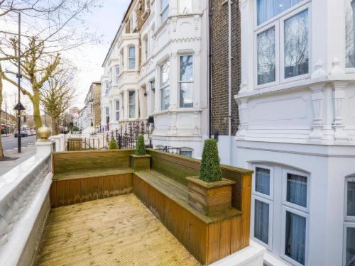 a balcony of a white building with potted plants at Orlando hotel in London