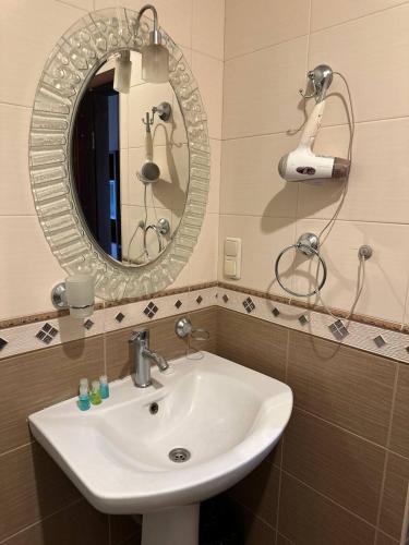 a bathroom with a white sink and a mirror at Hotel Nork Residence in Yerevan