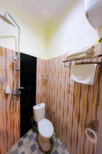 a bathroom with a toilet and a shower at Mora Residence Jimbaran in Jimbaran