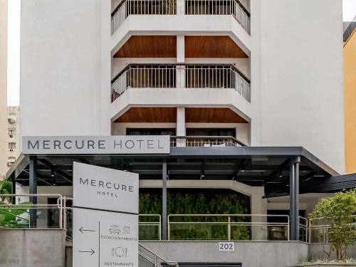 a hotel building with a sign in front of it at Mercure Sao Paulo Alamedas in Sao Paulo