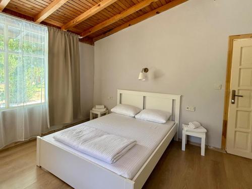 a bedroom with a white bed and a window at With the comfort of home in Kemer