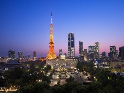 a city skyline with the eiffel tower at night at Tokyo Prince Hotel in Tokyo