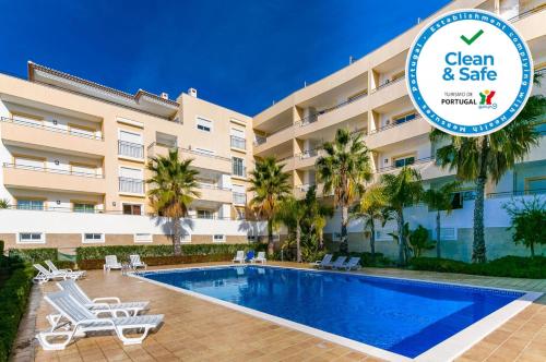 a hotel with a swimming pool in front of a building at A05 - Luxury 1 Bed Fully Equipped with Pool in Lagos
