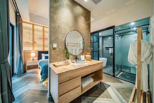 a bathroom with a sink and a mirror at Heinemann Hotel courtyard or terrace king room B106 with a jacuzzi and a local in Baoguosi