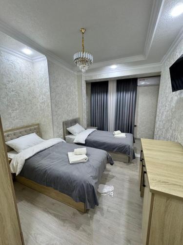 Ένα ή περισσότερα κρεβάτια σε δωμάτιο στο Old Saroy Hotel