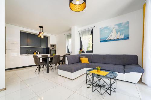 a living room with a couch and a table at Villa Essenza Rossa in Vodice only 650 meters from the beach in Vodice