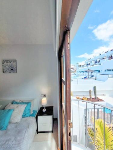 a bedroom with a bed and a balcony with a view at Suite adeje paradise with private jacuzzi in Adeje