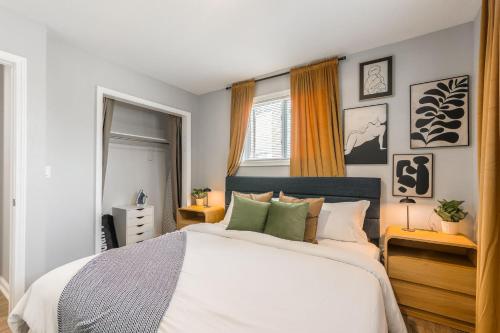 a bedroom with a bed with white sheets and green pillows at Home in Kansas City 15 mins to KCI with a KING bed and workspace in Riverside