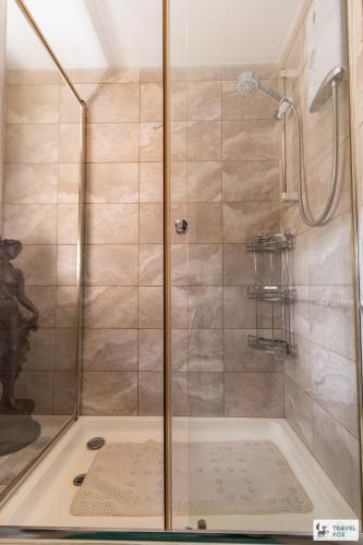 a shower with a glass door in a bathroom at Central Aster House, 3 Bedrooms, Parking in Nottingham