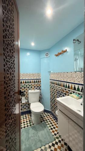 a bathroom with a toilet and a sink at Riad d'Art de Fès in Fès al Bali