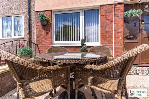 a patio table with three chairs and a table with at Central Aster House, 3 Bedrooms, Parking in Nottingham