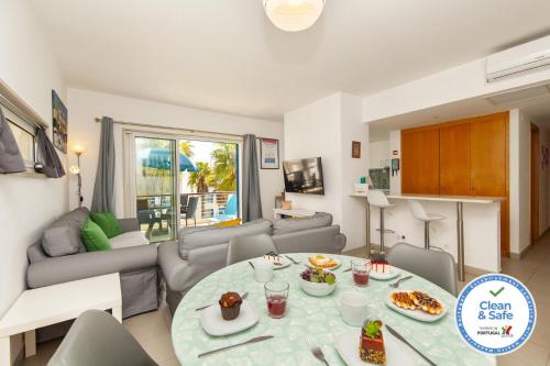 a living room with a table and a couch at B06 - Top-Floor Marina 2 Bed Apartment in Lagos