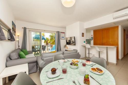 a living room with a table and a couch at B06 - Top-Floor Marina 2 Bed Apartment in Lagos