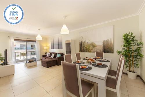 a dining room and living room with a table and chairs at B03 - Luxury 2 Bed near Lagos Marina in Lagos