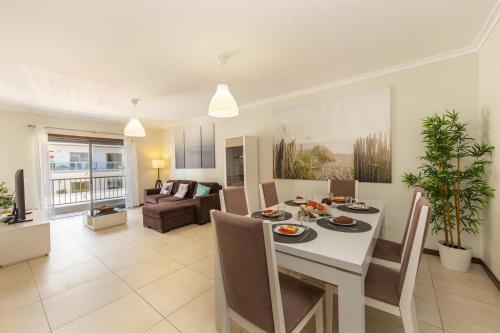 a dining room and living room with a table and chairs at B03 - Luxury 2 Bed near Lagos Marina in Lagos